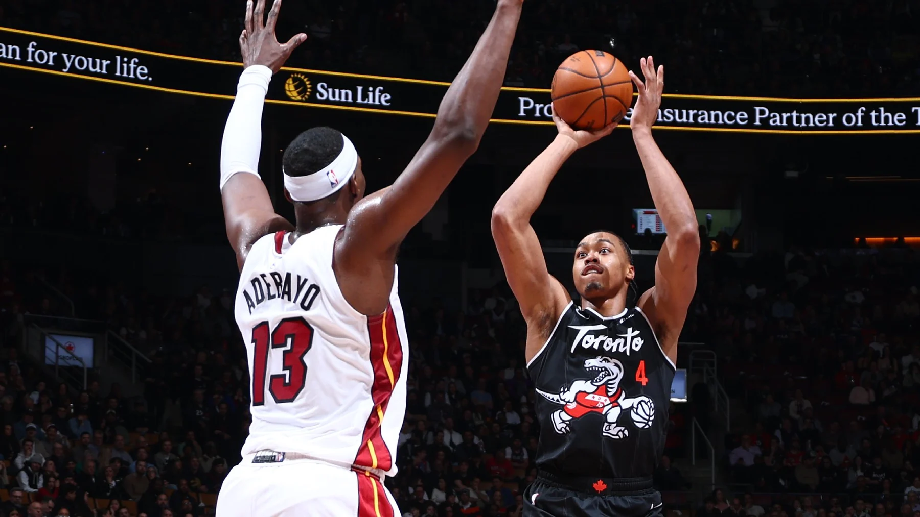 Bam Adebayo contests Scottie Barnes in a Miami Heat versus Toronto Raptors game