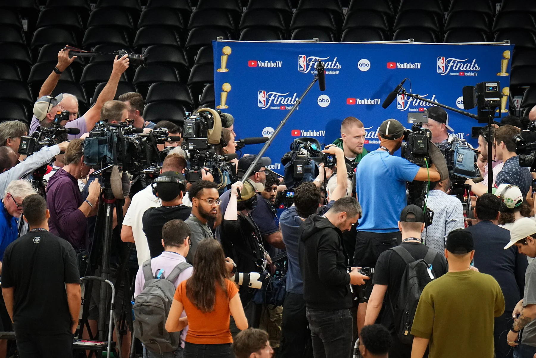 Basketball reporters and television cameras covering an NBA arena event