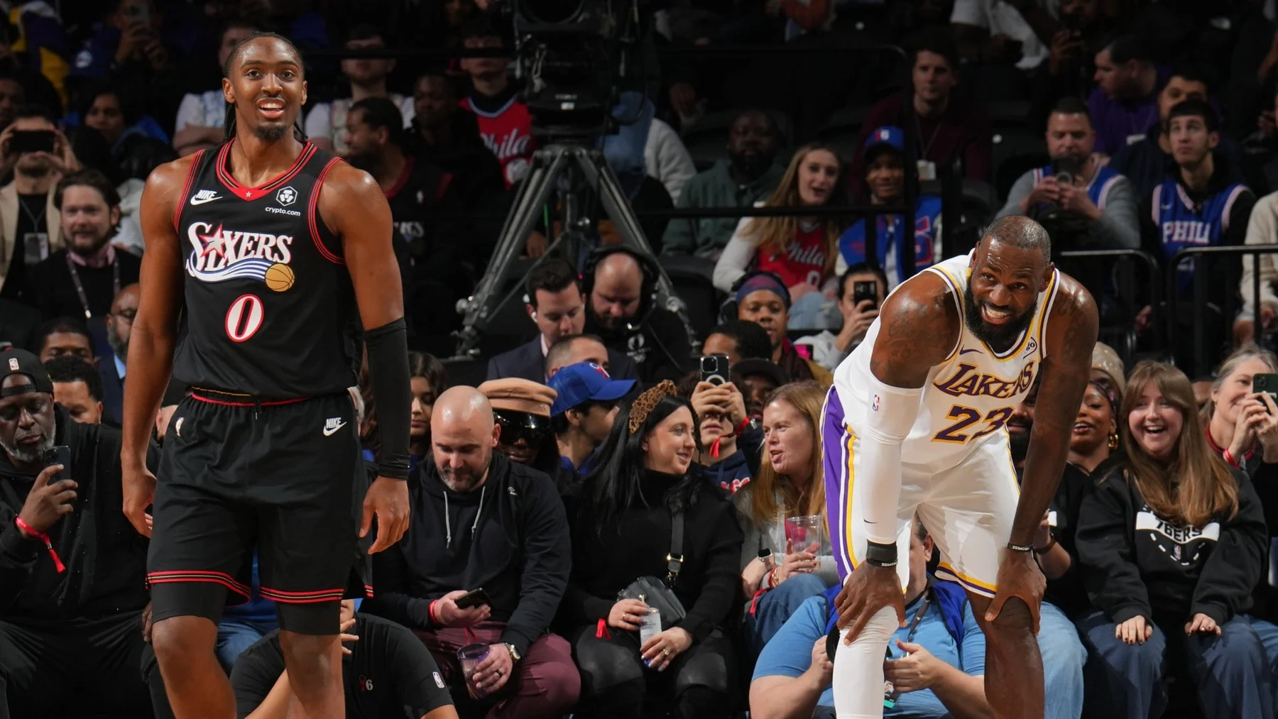 Tyrese Maxey and LeBron James sharing the court during a Sixers-Lakers game