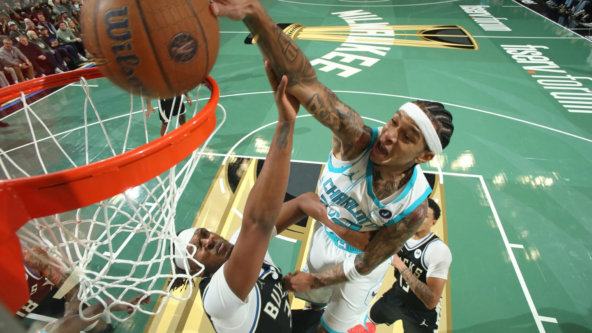 Charlotte forward Brandon Miller attacking the rim against Milwaukee defenders during 2025 NBA Cup Group Play