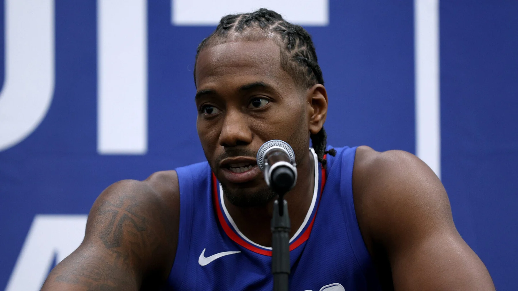 Kawhi Leonard speaking into a microphone during LA Clippers media day