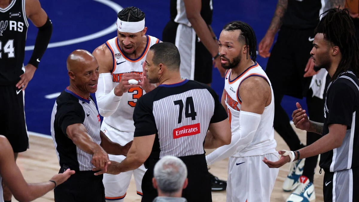 New York Knicks and San Antonio Spurs players with an official during Game 3 of the 2026 NBA Finals
