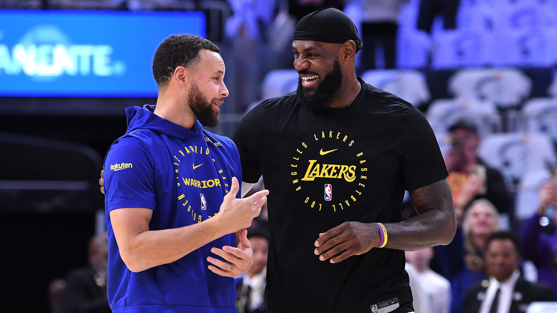 Stephen Curry and LeBron James talking courtside before a Warriors-Lakers game