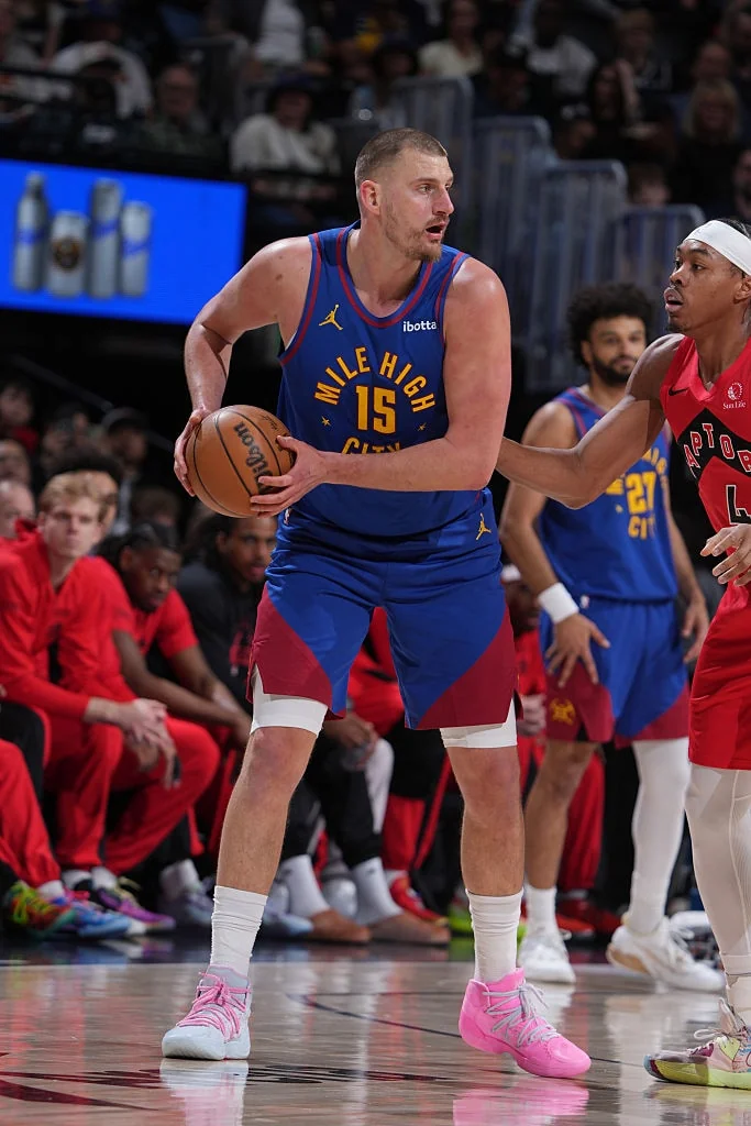 Nikola Jokic directing the Denver Nuggets offense during an NBA game