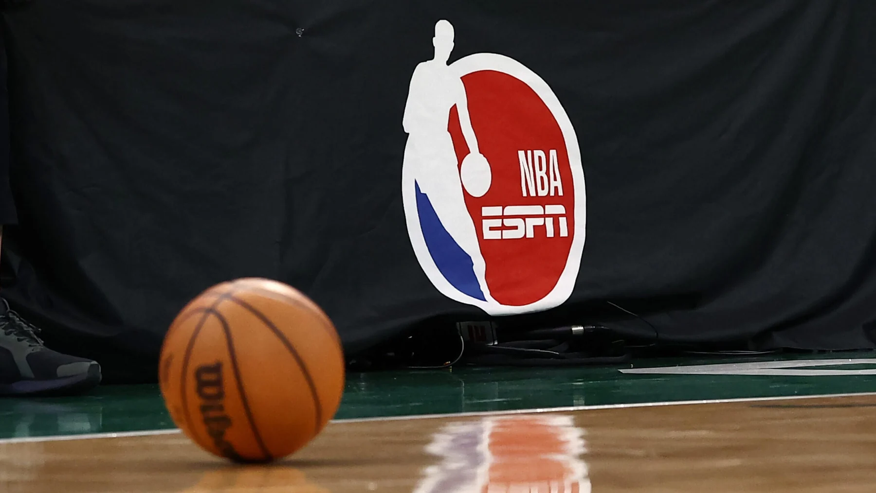NBA on ESPN branding beside a basketball at courtside