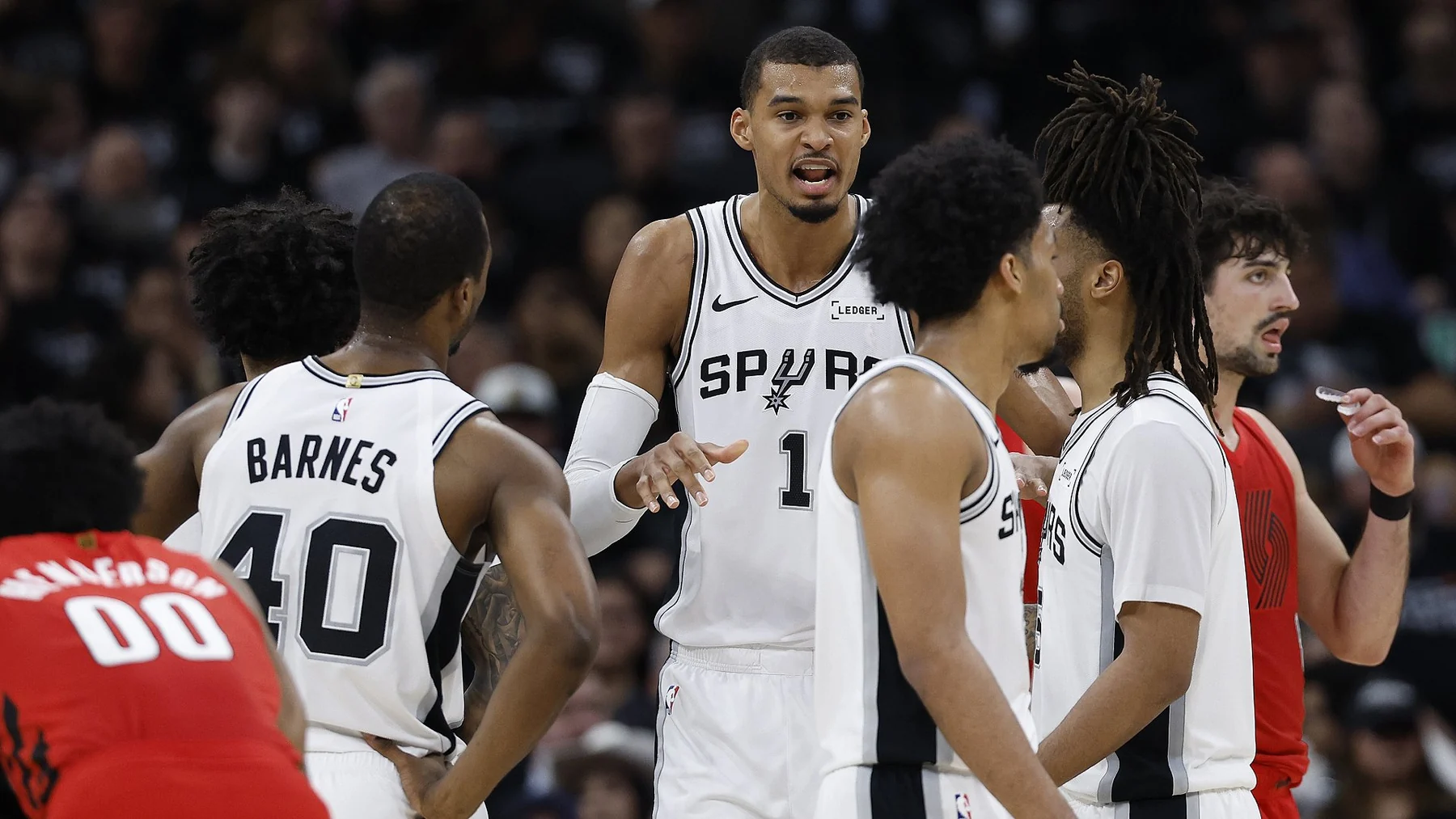 Victor Wembanyama directs San Antonio Spurs teammates during a game against Portland